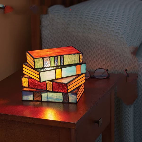Stacked books stained-glass desk lamp in a dramatic home decor setting