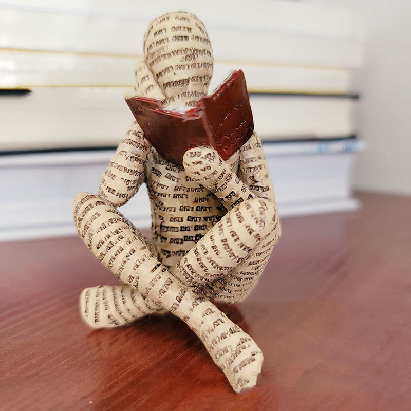 Abstract woman reading figurine displayed as unusual study-space decor